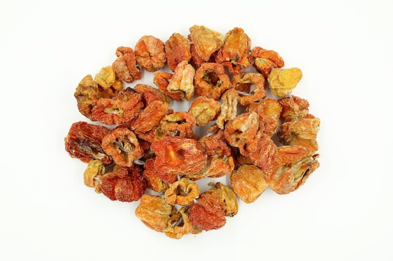 A collection of spicy dried peppers arranged on a white background, perfect for culinary themes.